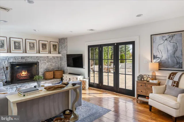 a kitchen with stainless steel appliances granite countertop a refrigerator a stove and white cabinets with wooden floor