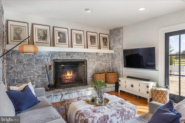 a kitchen with stainless steel appliances granite countertop a sink a stove and a wooden floors