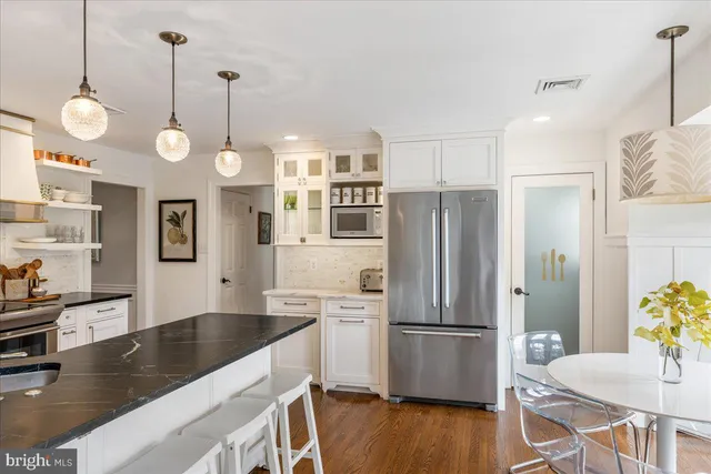 a work room with furniture a rug and a window