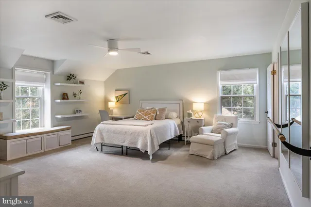 a bedroom with a bed and a large window