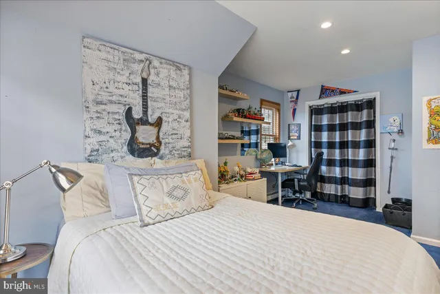 a view of a chairs and table in the patio next to a yard