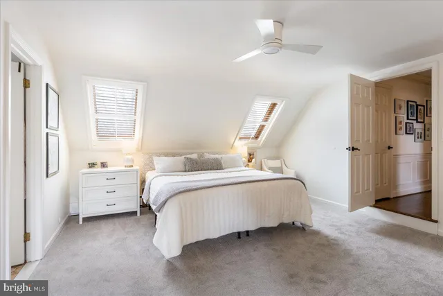 a front view of a house with yard and trees