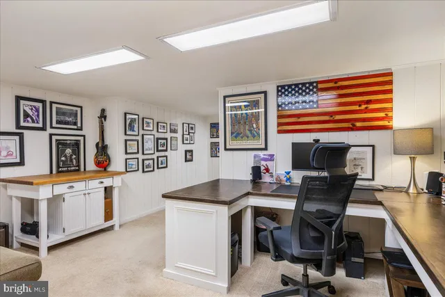 a picture of a room with a white wall and a painting