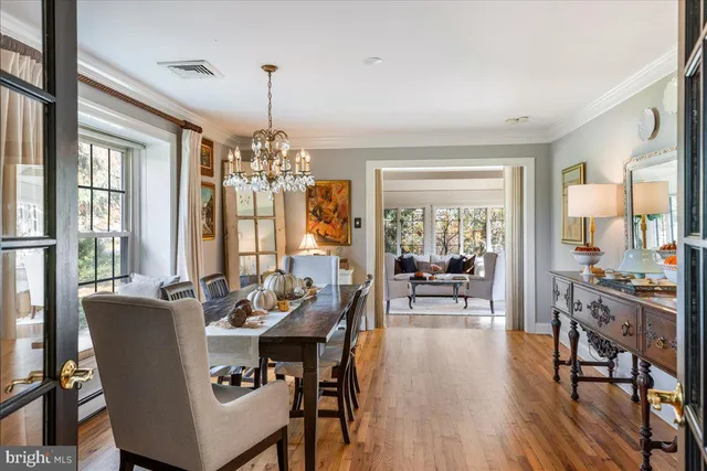 a living room with furniture and floor to ceiling windows