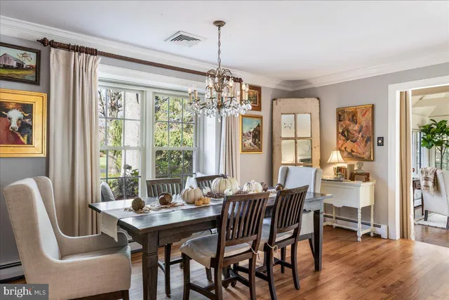 a living room with furniture and floor to ceiling windows