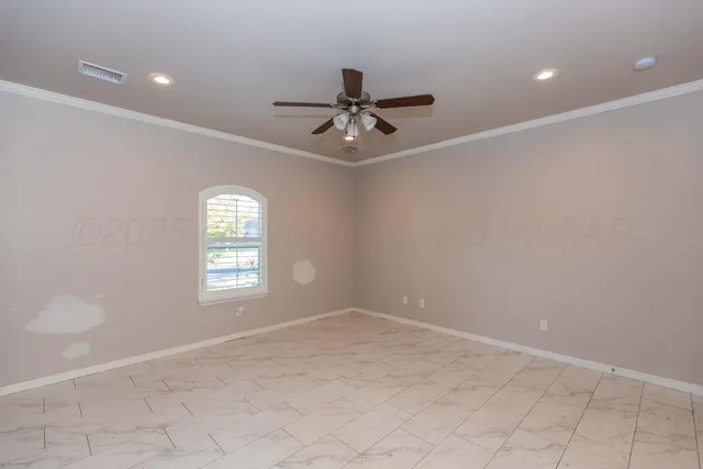 an empty room with windows and fan