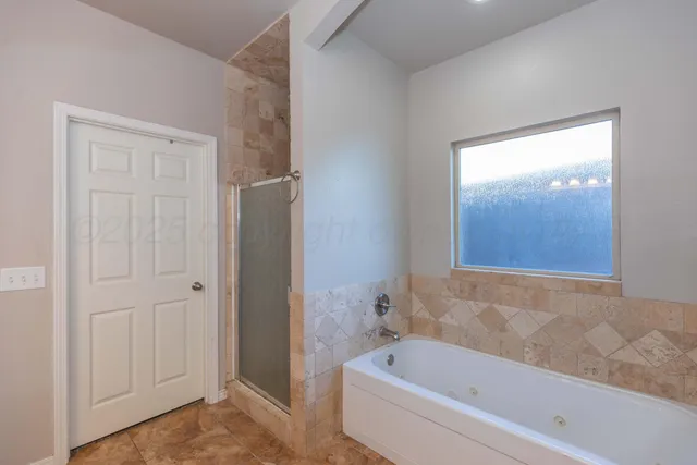 a bathroom with a bathtub and shower