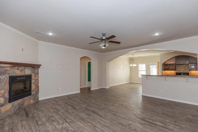 a view of a livingroom with a fireplace and window