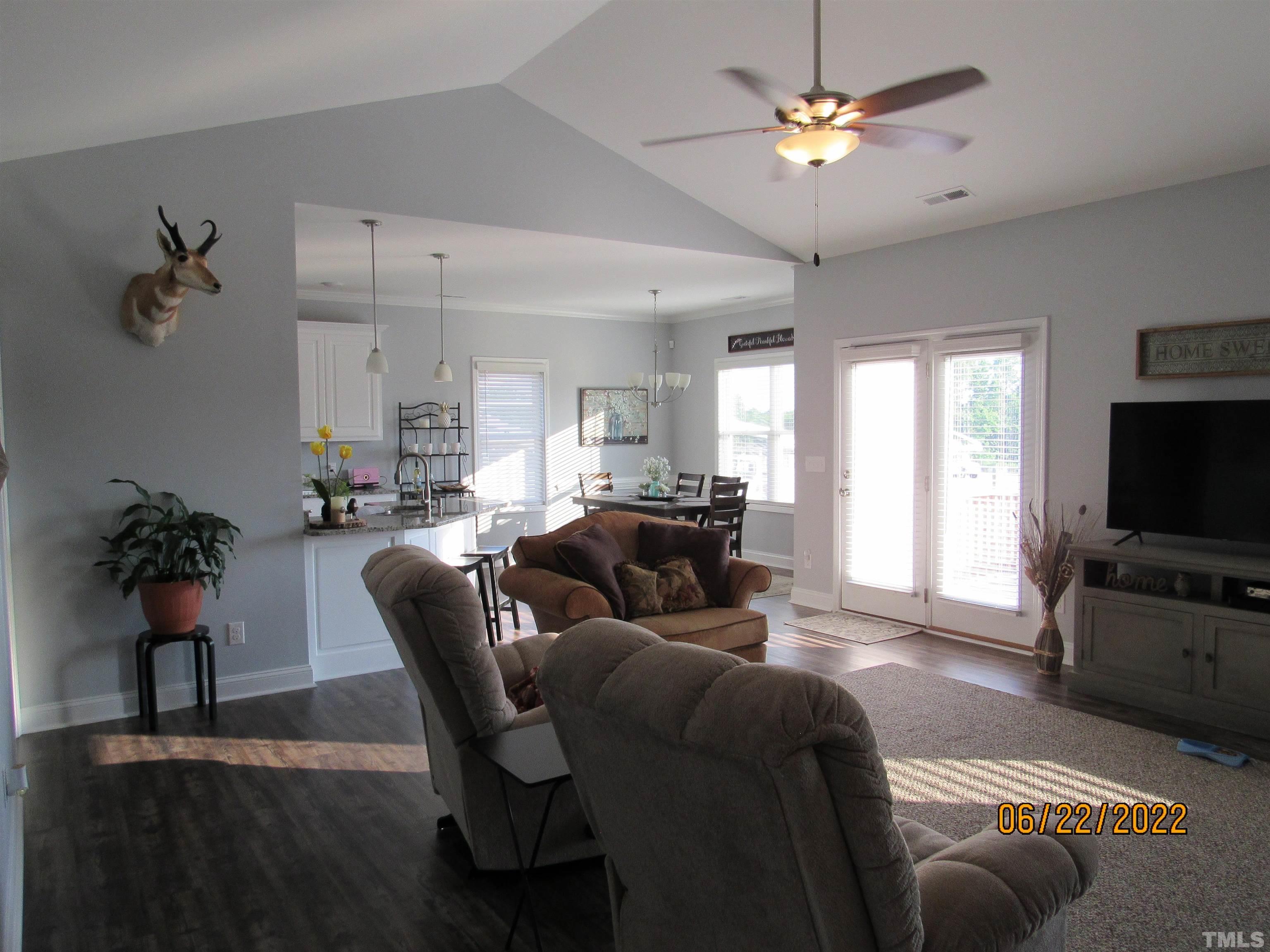 3167 Baileys Crossroads Road Benson, NC 27504 - Photo 11 of 29 a living room with furniture a chandelier and a flat screen tv