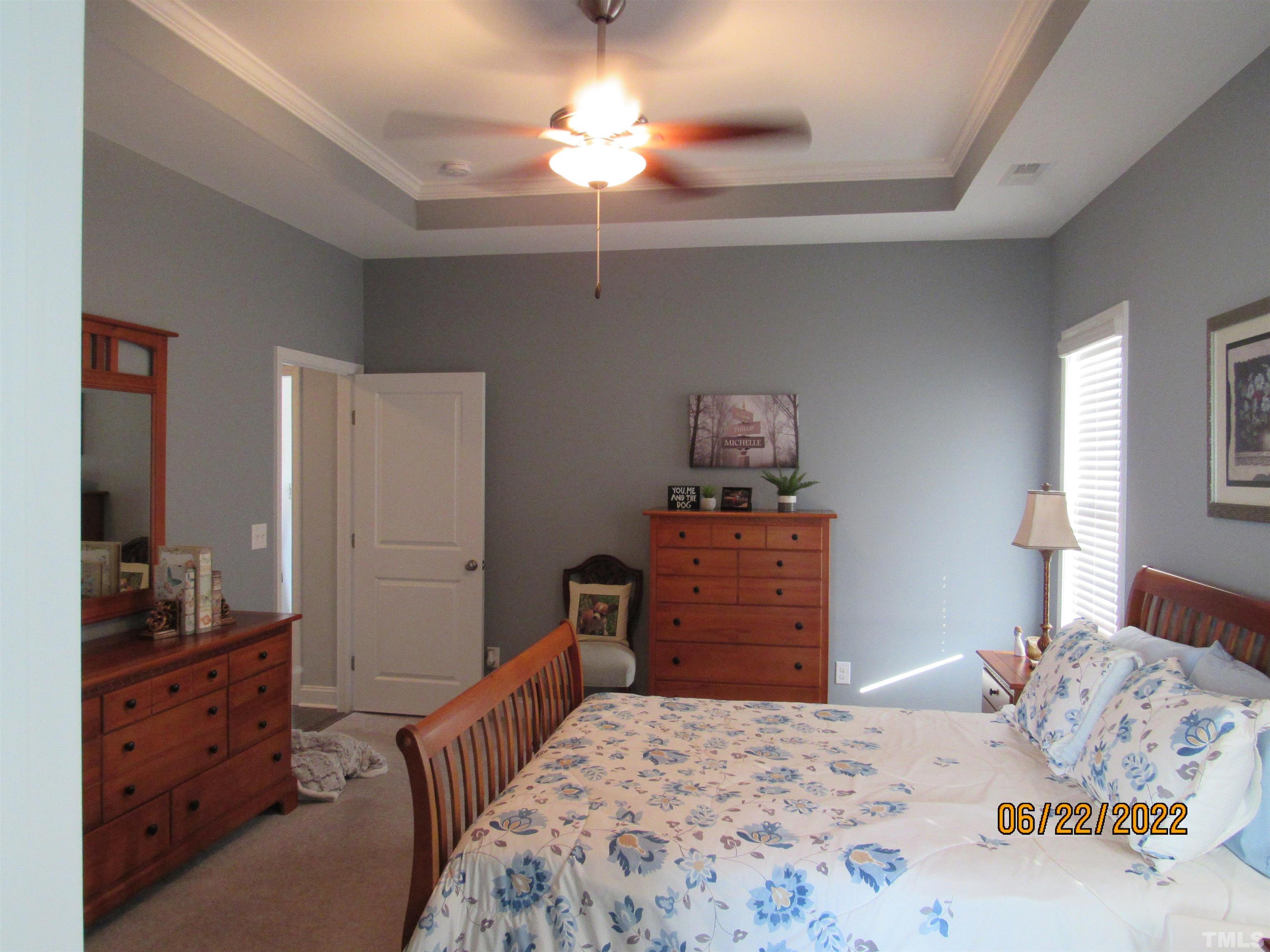3167 Baileys Crossroads Road Benson, NC 27504 - Photo 9 of 29 a bedroom with a bed and a dresser in it