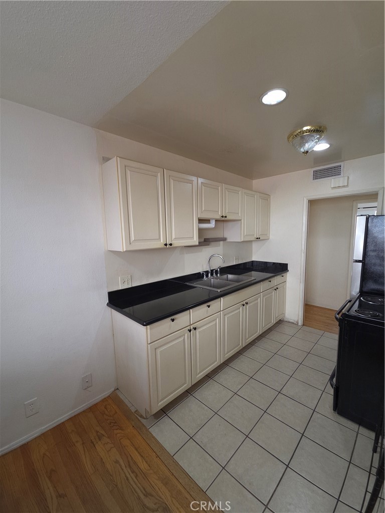 522 Cedar Avenue, Unit 3 Long Beach, CA 90802 - Photo 1 of 14 a kitchen with stainless steel appliances granite countertop a sink and a stove