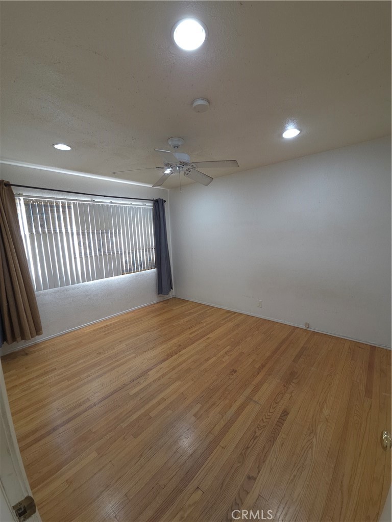 522 Cedar Avenue, Unit 3 Long Beach, CA 90802 - Photo 13 of 14 an empty room with wooden floor and windows
