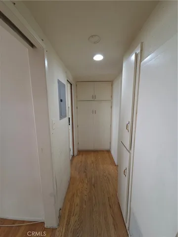 a view of a hallway with wooden floor