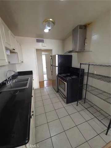 a kitchen with a sink a stove and a microwave