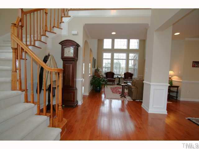 12439 Pawleys Mill Circle Raleigh, NC 27614 - Photo 2 of 12 a living room with fireplace furniture and a wooden floor