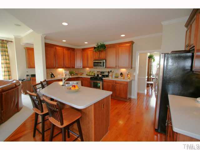 12439 Pawleys Mill Circle Raleigh, NC 27614 - Photo 6 of 12 a large kitchen with a table and chairs