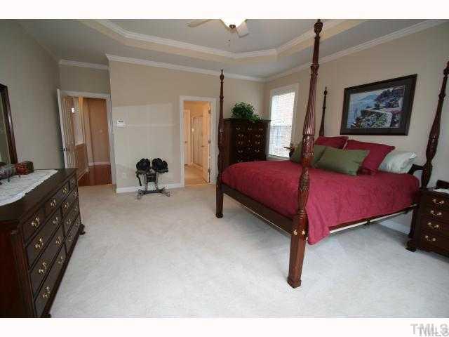12439 Pawleys Mill Circle Raleigh, NC 27614 - Photo 8 of 12 a bedroom with a bed and a dresser
