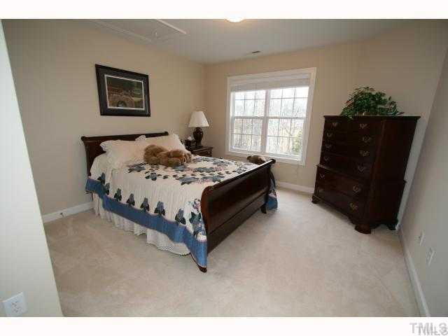 12439 Pawleys Mill Circle Raleigh, NC 27614 - Photo 9 of 12 a bedroom with a bed and window