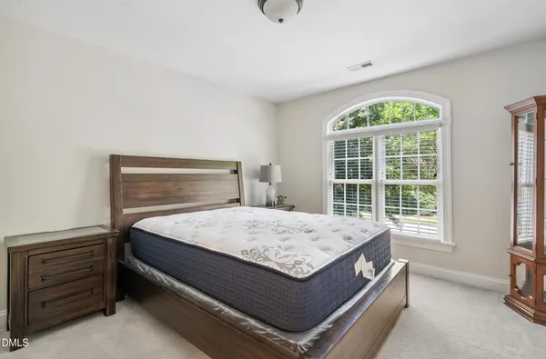 a spacious bedroom with a bed and a couch