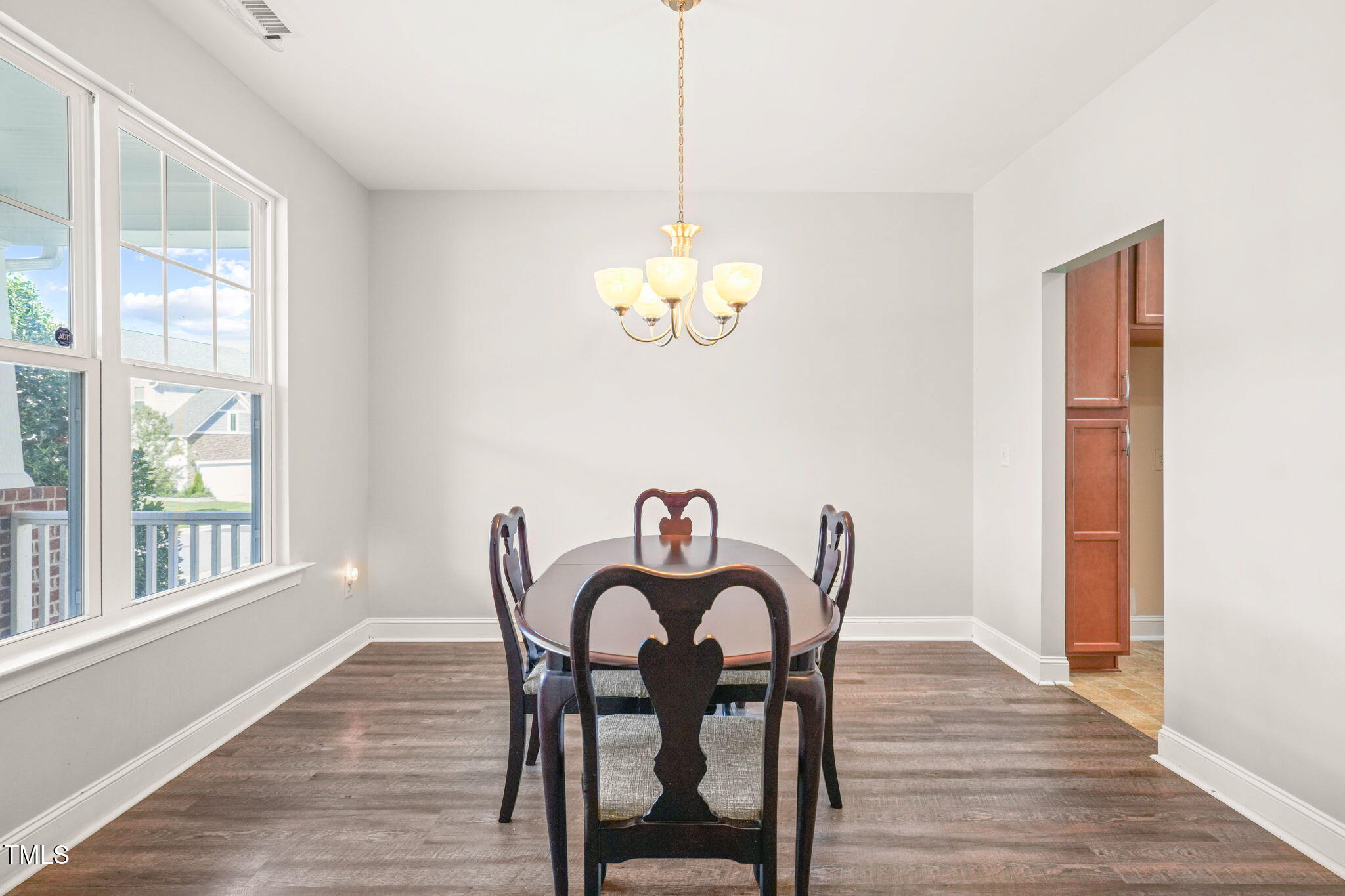 4508 Brintons Cottage Street Raleigh, NC 27616 - Photo 15 of 46 a view of a dining room with furniture a chandelier and wooden floor