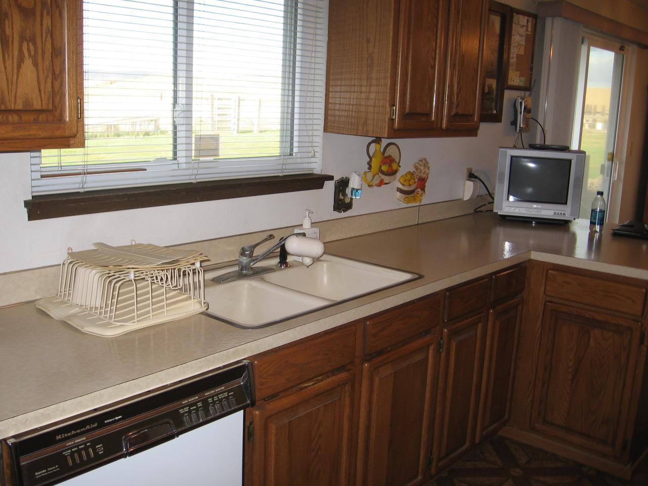 2411 Lateral 1 Road Wapato, WA 98951 - Photo 4 of 12 a kitchen with granite countertop a sink stove and cabinets