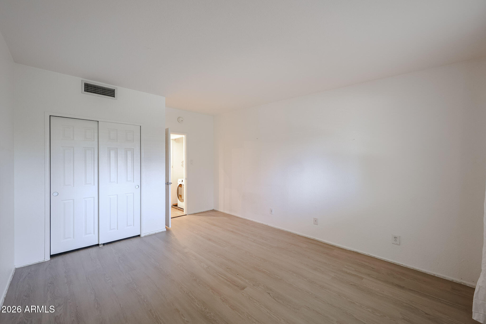 357 East Thomas Road, Unit A208 Phoenix, AZ 85012 - Photo 22 of 36 a view of an empty room and wooden floor