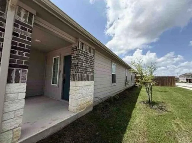 a view of house with backyard