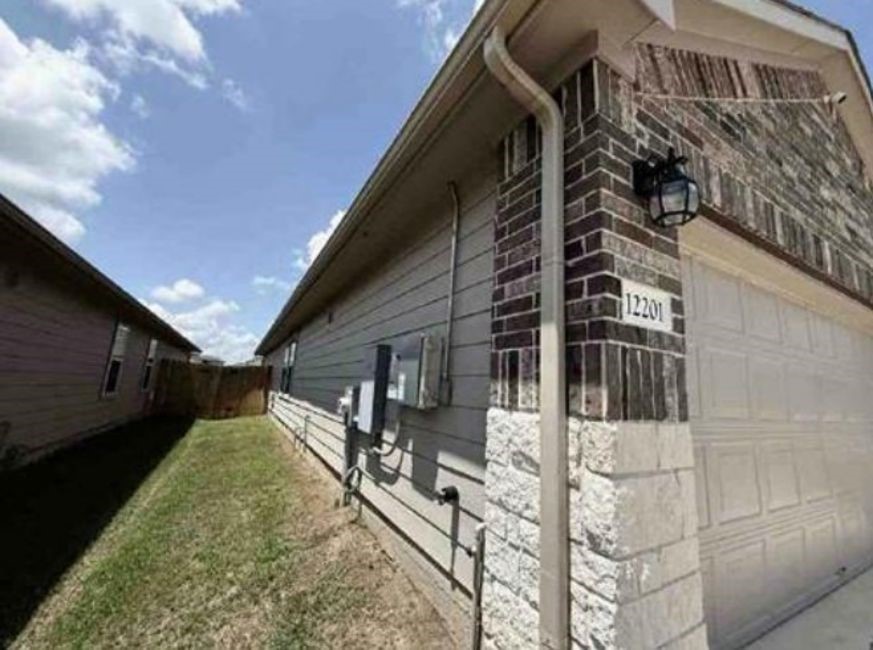 12201 Token Trail Elgin, TX 78621 - Photo 3 of 6 a view of a house with a yard