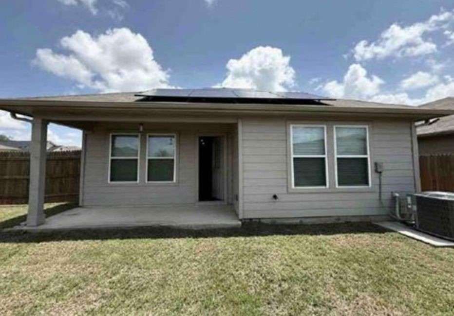12201 Token Trail Elgin, TX 78621 - Photo 4 of 6 a front view of a house with a yard