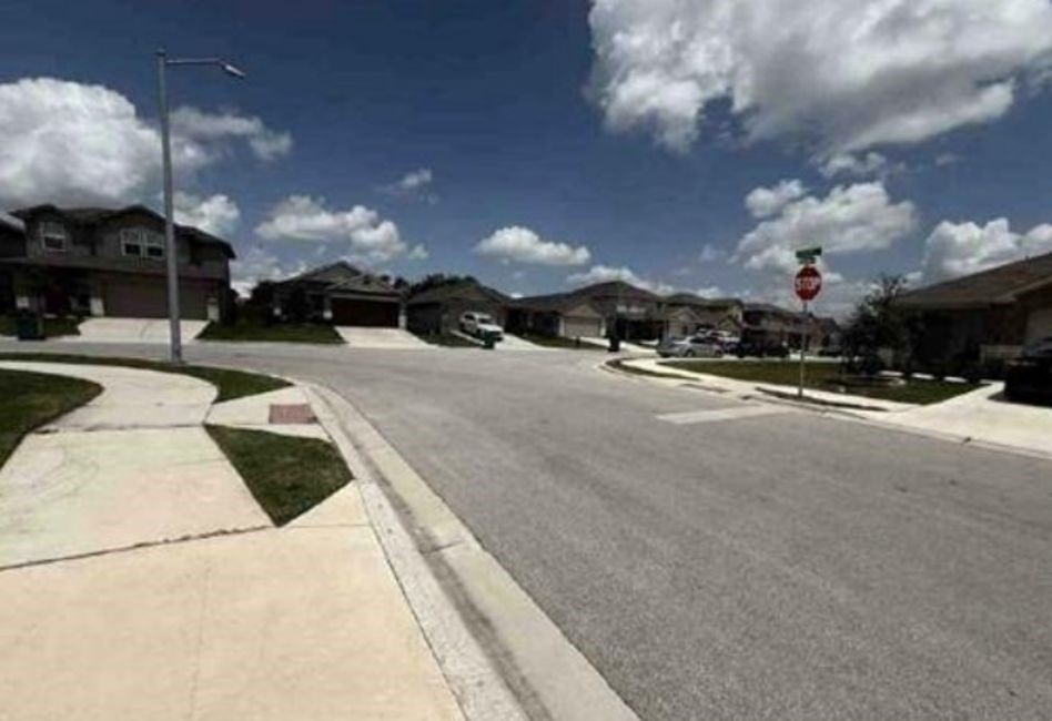 12201 Token Trail Elgin, TX 78621 - Photo 6 of 6 a view of a street with a building in the background