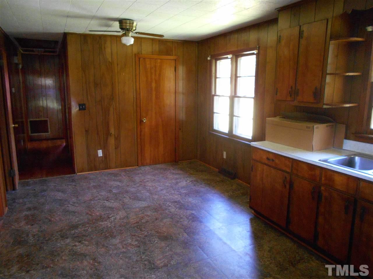 910 Mackfieldson Road Roxboro, NC 27574 - Photo 3 of 10 a view of hallway with window and wooden cabinets