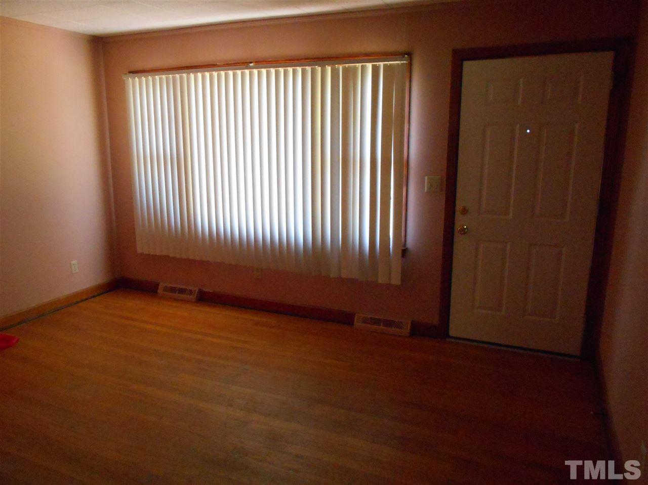 910 Mackfieldson Road Roxboro, NC 27574 - Photo 4 of 10 an empty room with windows