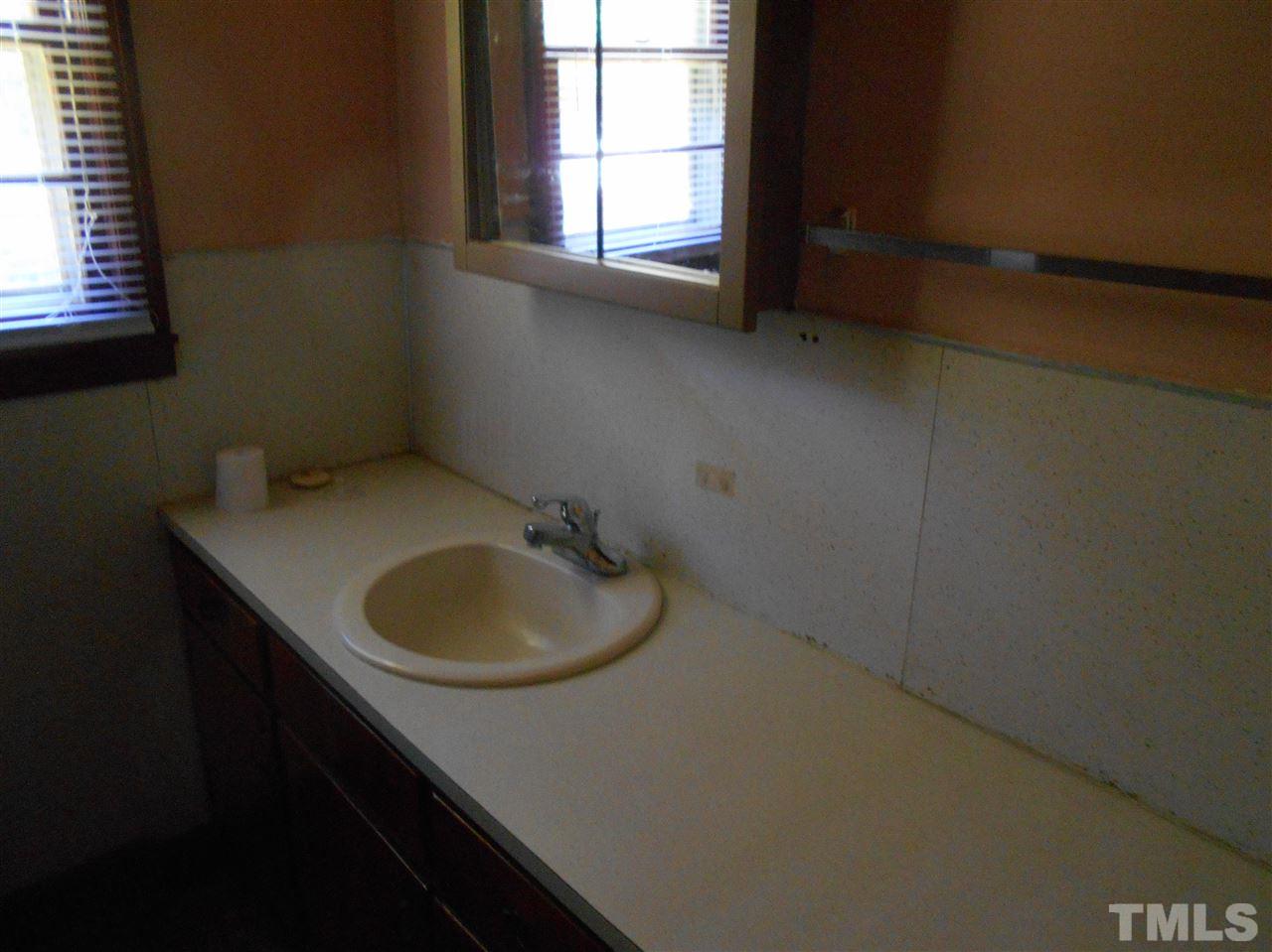 910 Mackfieldson Road Roxboro, NC 27574 - Photo 6 of 10 a bathroom with a sink toilet vanity and window