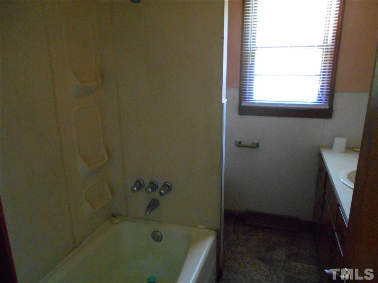 910 Mackfieldson Road Roxboro, NC 27574 - Photo 7 of 10 a bathroom with a bathtub