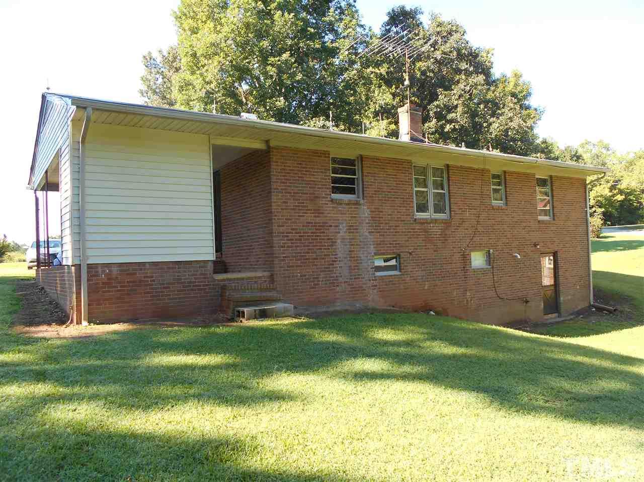 910 Mackfieldson Road Roxboro, NC 27574 - Photo 9 of 10 a view of a backyard with potted plants and large tree