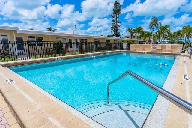 a view of a swimming pool with outdoor seating