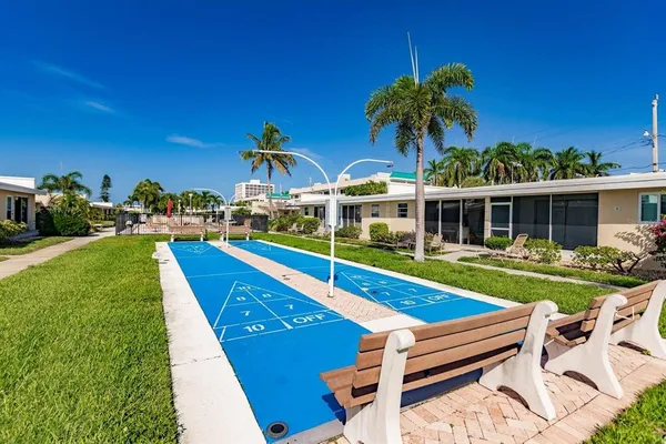 a view of a house with pool and chairs