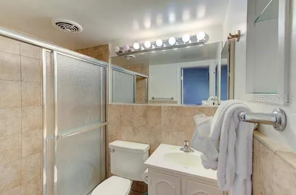 a bathroom with a sink a mirror and a toilet