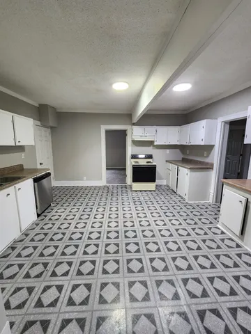 a bathroom with a sink a toilet a mirror and a shower