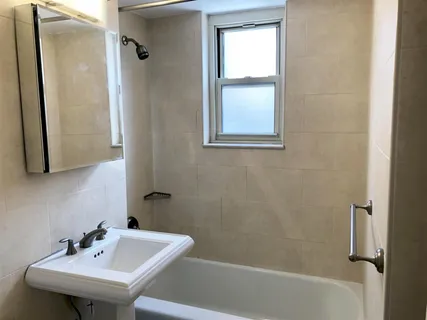 a bathroom with a sink a mirror and a bathtub
