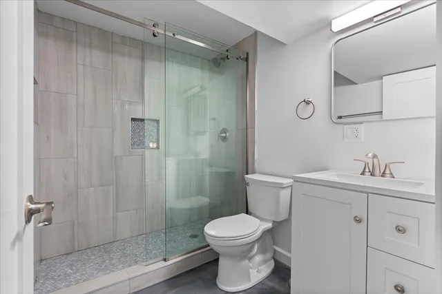 a bathroom with a toilet a sink and shower