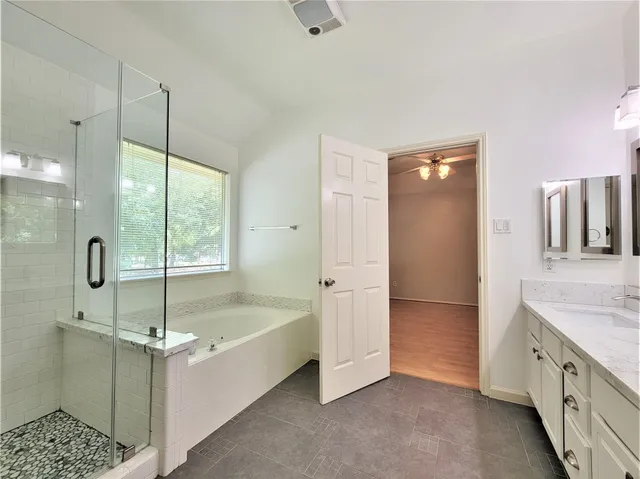 a bathroom with a tub sink and shower