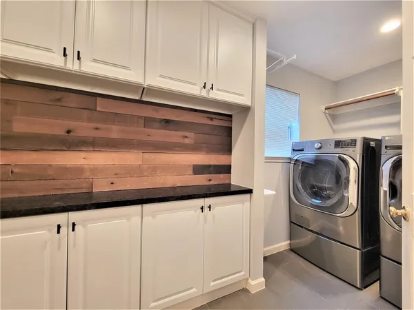 a close view of utility and utility room with washer and dryer