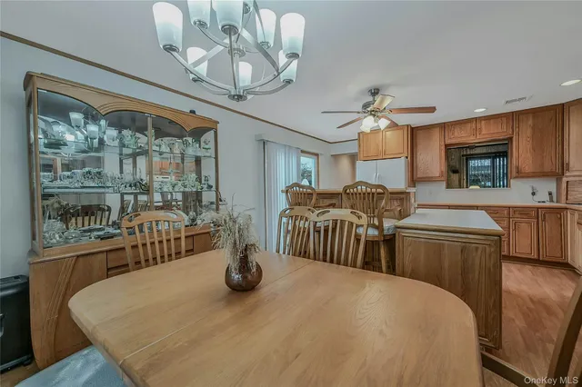a view of a dining room with furniture a chandelier and wooden floor