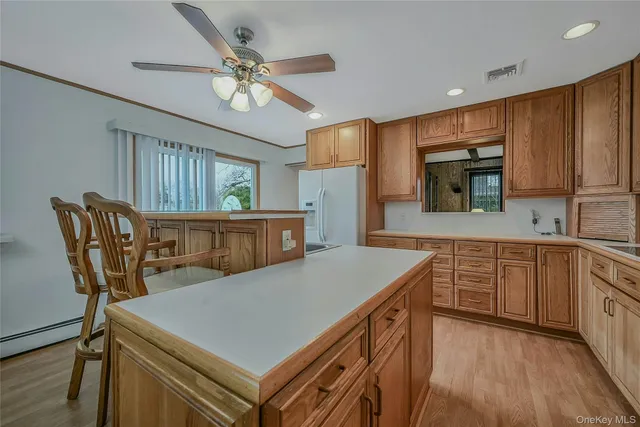 a kitchen with cabinets table and chairs