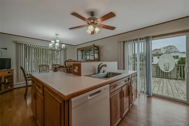 a kitchen with stainless steel appliances granite countertop a sink a stove top oven a chimney and a refrigerator