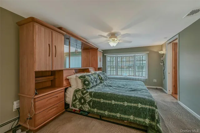 a bed sitting in a bedroom next to a window