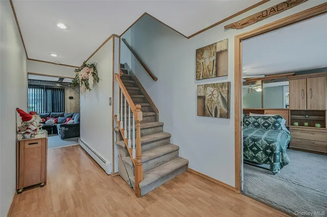 a view of entryway and hall with wooden floor