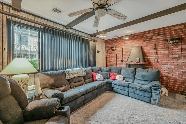 a living room with furniture and a ceiling fan