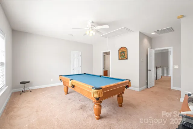 a room with pool table and window